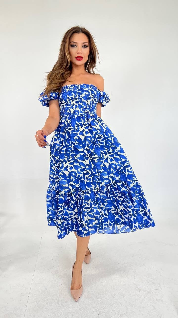 Front view of model wearing blue off the shoulder dress