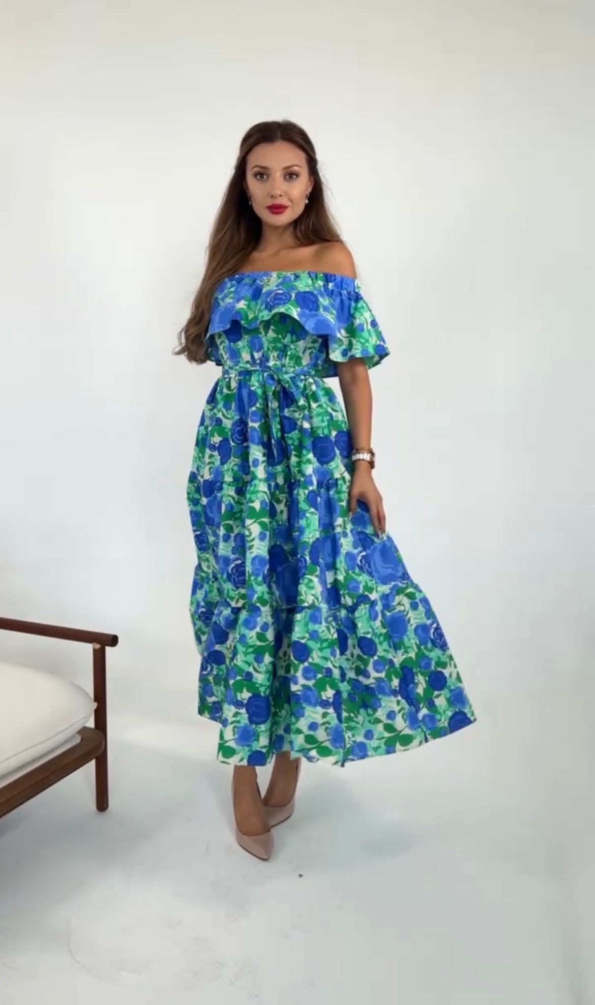 Model posing wearing off the shoulder ruffle hem floral print dress